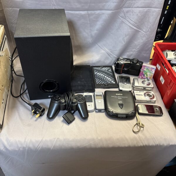 LG wireless subwoofer with mobile phones and camera in a mixed lot.