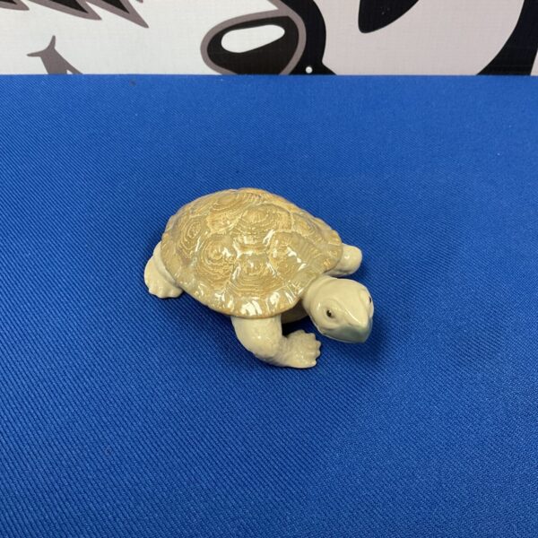 Detailed Lladro porcelain tortoise figurine for collectors.