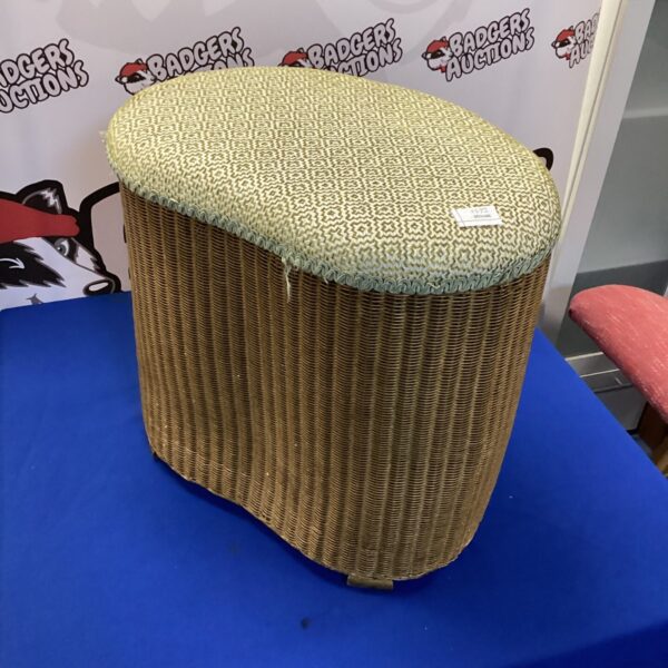 Vintage Lloyd Loom wash bin with woven texture and pale green colour.