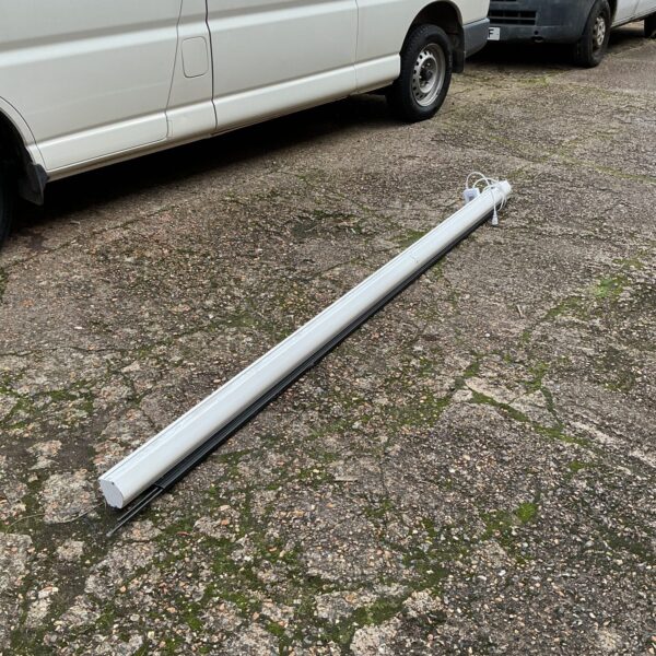 Lucburg electric projector screen in a storage area.