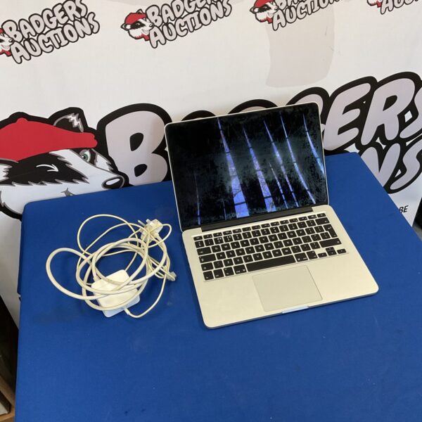 Silver Apple MacBook Pro A1502 laptop with charger.