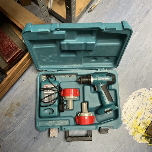 Vintage Makita cordless drill set with charger in carrying case.