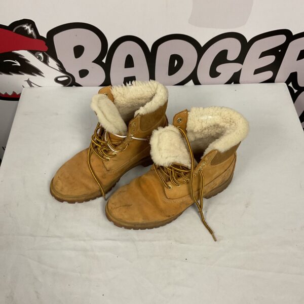 Side view of worn men’s Timberland boots with leather uppers.