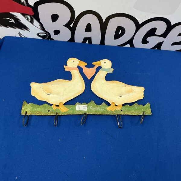 Vintage metal duck kitchen hanger with multiple hooks for storage.