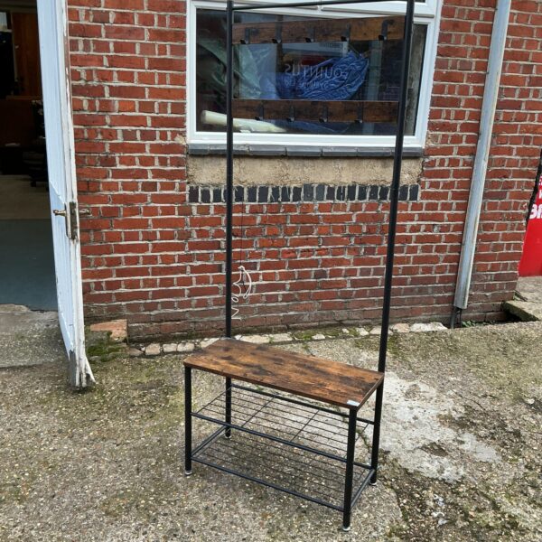 Rustic metal and wood coat and shoe rack for hallway storage.