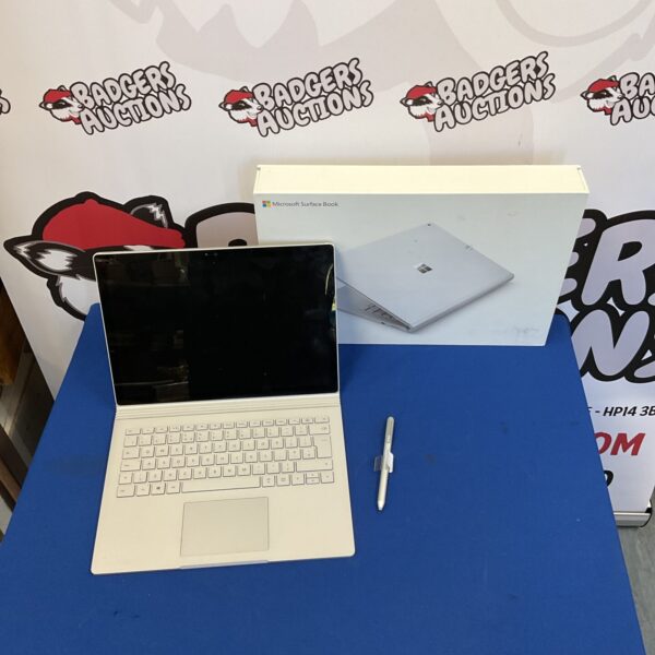 Silver Microsoft Surface Book laptop, open and displayed.