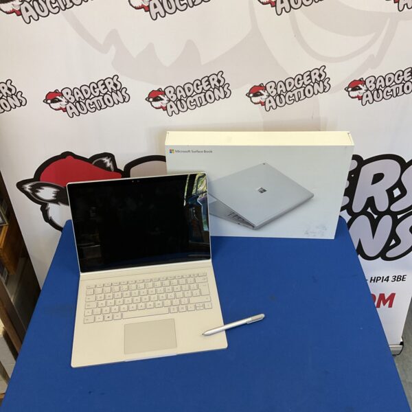 Silver Microsoft Surface Book laptop, open and displayed.