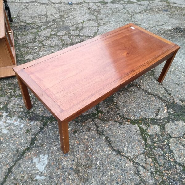 Vintage mid-century modern coffee table with warm wood tones.