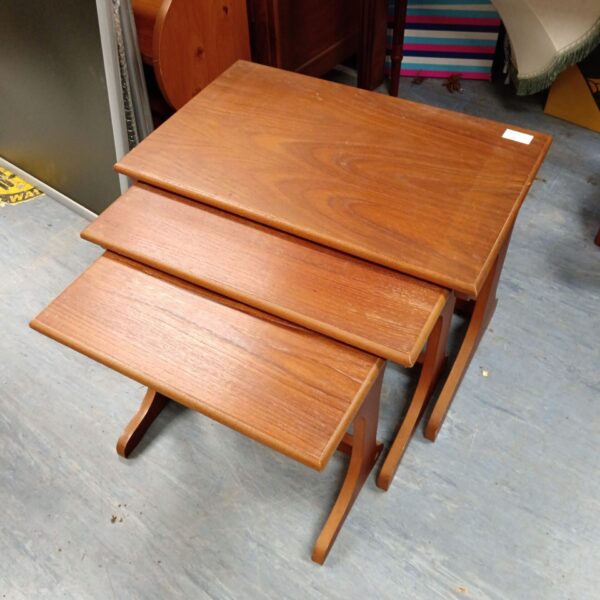 Vintage mid-century nest of tables with warm wood finish.