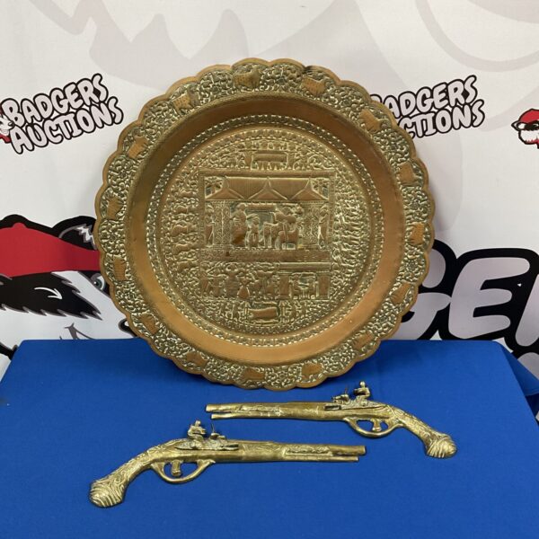 Antique Middle Eastern copper charger with intricate embossed design.