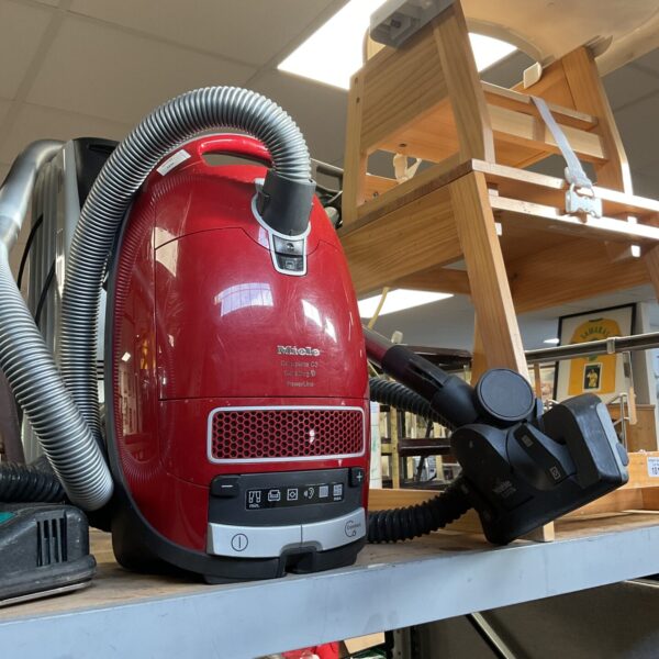 Miele ecoteq vacuum cleaner in used condition, side view.