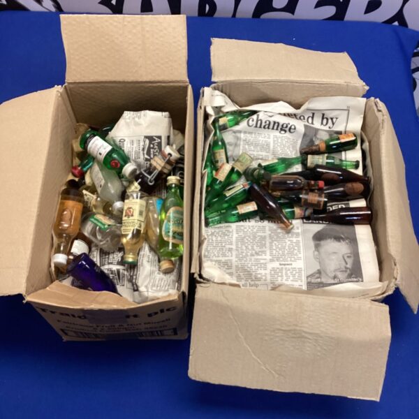 Lot of miniature alcohol bottles including Tanqueray Gin and Royalty Vodka.