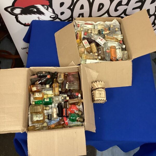 Lot of miniature alcohol bottles including ouzo and brandy.