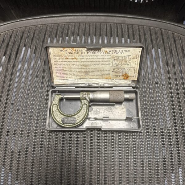 Vintage Mitutoyo 0-25mm micrometer in open case, precision measurement tool.
