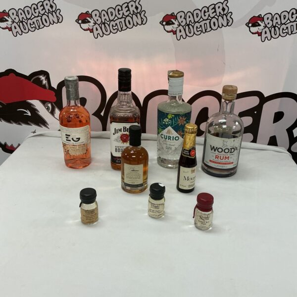 Mixed alcohol lot featuring miniature bottles of rum, tequila, and whiskey.