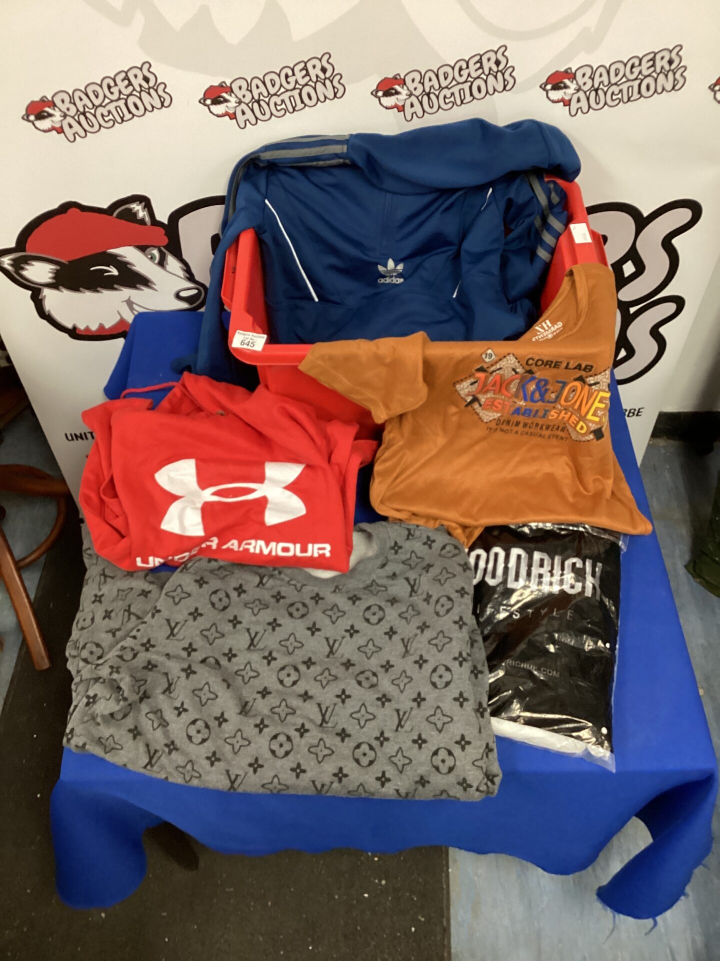 Mixed clothing lot featuring Adidas and Puma sportswear.