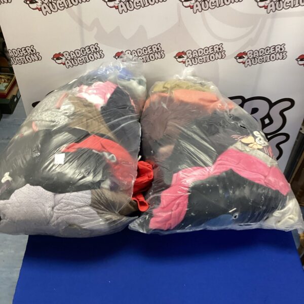 Two bags filled with a mixed clothing lot for sale.