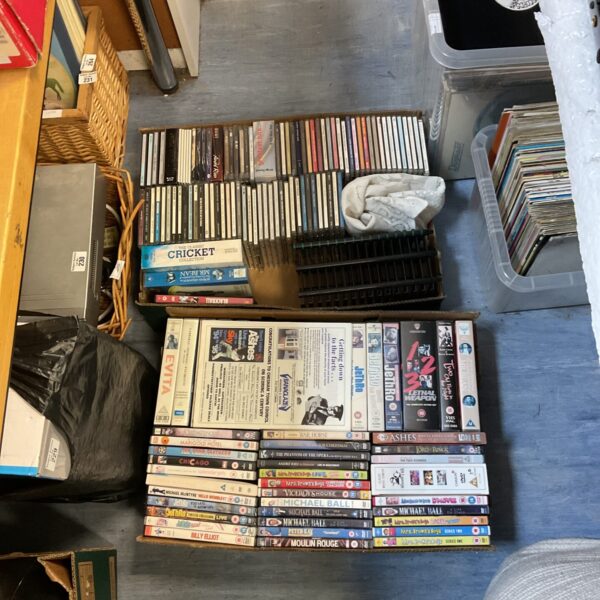 Mixed lot of DVDs and CDs for entertainment collection.