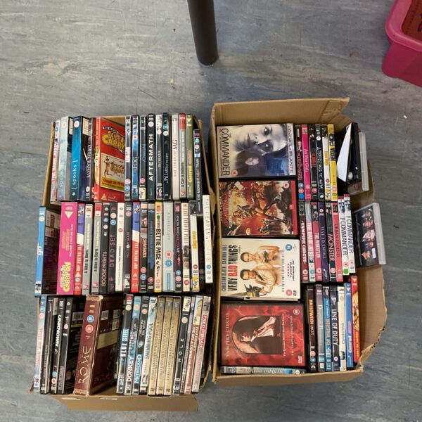 Overview of a mixed DVD lot with approximately two boxes of films.