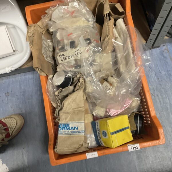 Tray of mixed electrical components and lamps for repair.