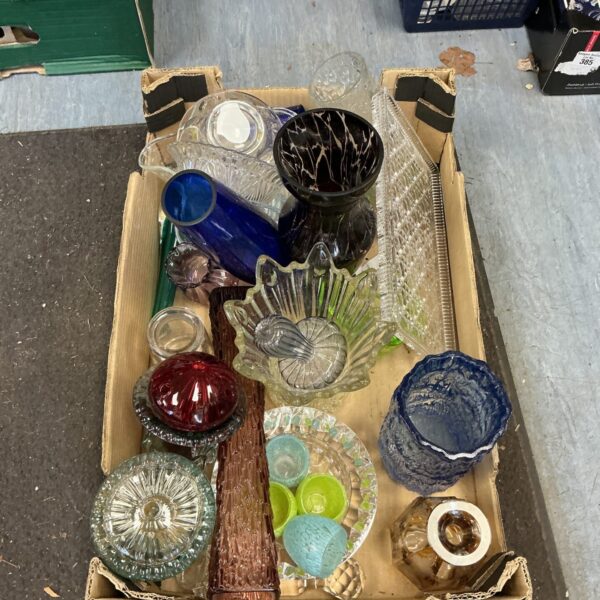 Mixed collection of colourful vintage glass vases and decorative items.