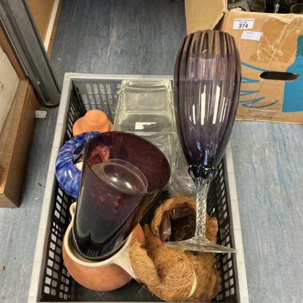 Assorted mixed glass vases including a tall purple vase.