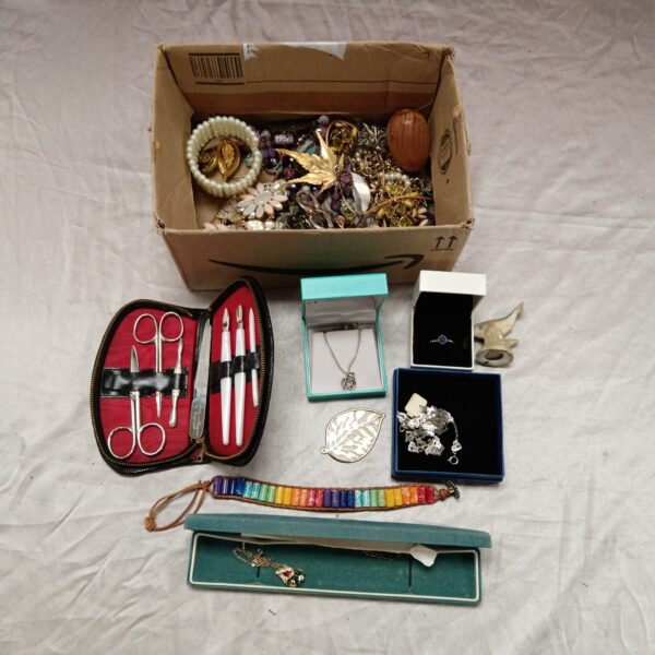 Mixed jewellery lot with a variety of necklaces, rings, and bracelets.