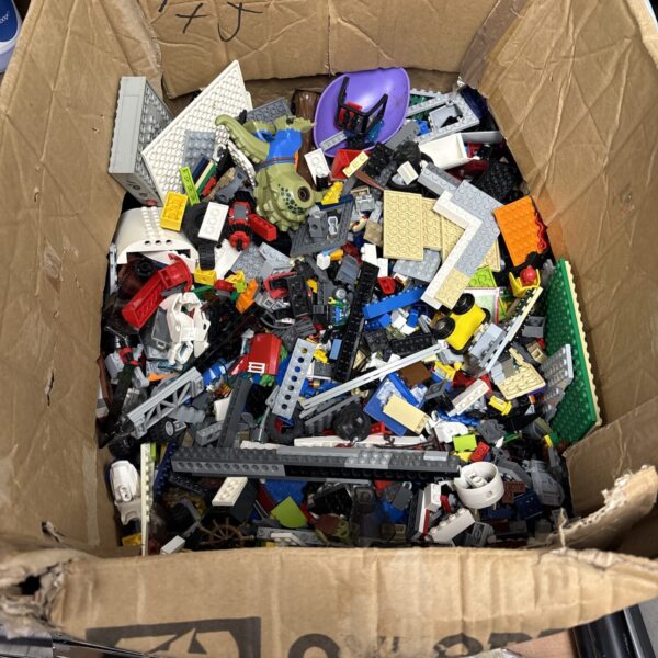 Large mixed Lego lot with assorted bricks and minifigures for building.