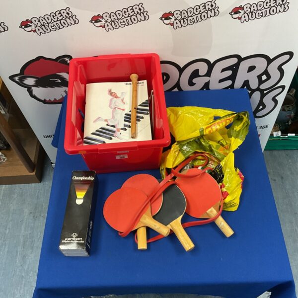 Mixed lot of ping pong racquets, shuttlecocks, and sheet music.