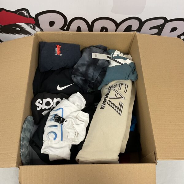 Box of mixed sportswear clothing items for various activities.
