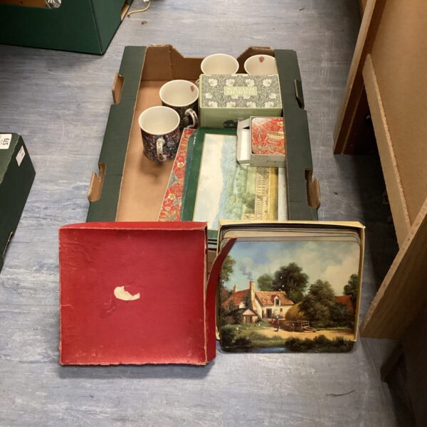Mixed tableware lot with colourful mugs and place mats.