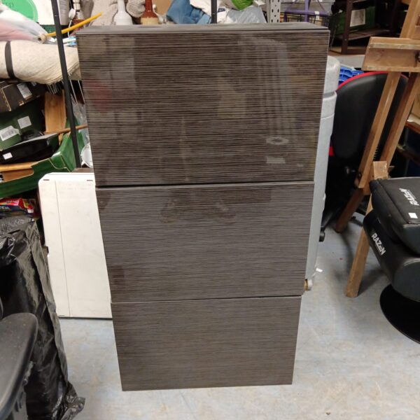 Front view of a modern striped lacquered wall cabinet.