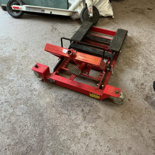 Hydraulic motorcycle jack for lifting and maintaining bikes.