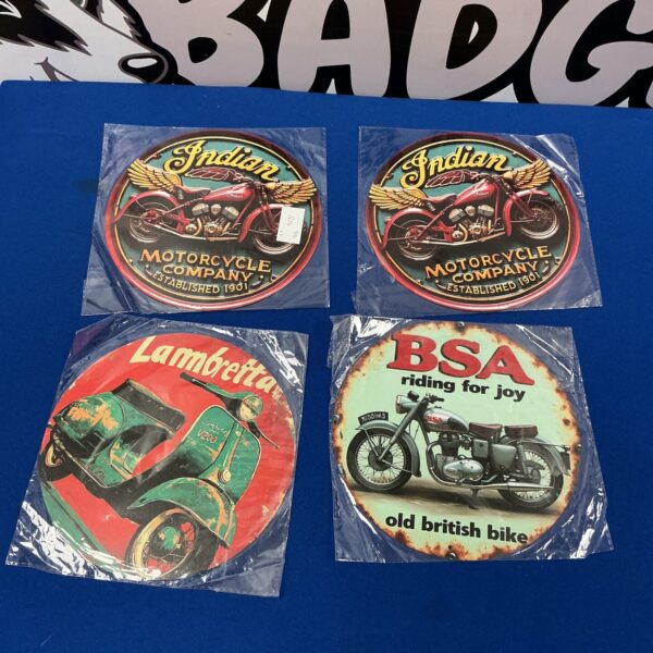 Vintage motorcycle advertising plaques for garage decor.