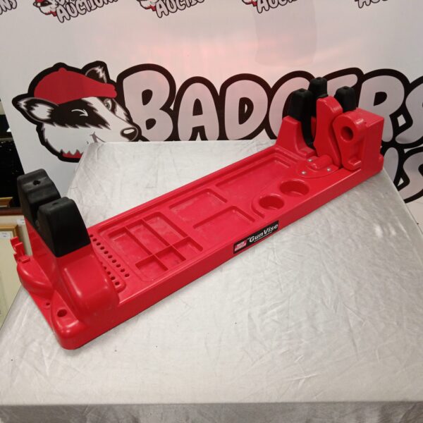 Red MTM gun vise workstation for firearm maintenance.