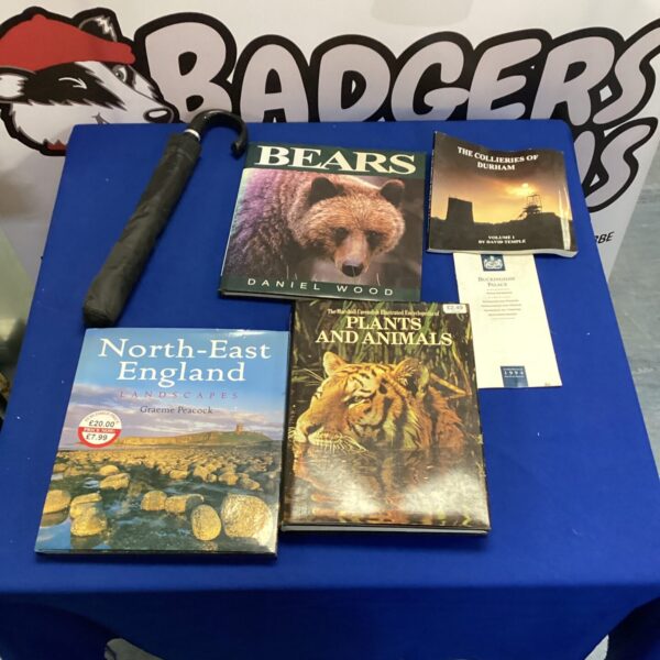 Vintage umbrella with a stack of nature and animal books.