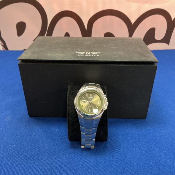 Silver analogue Navigator wristwatch with stainless steel band.
