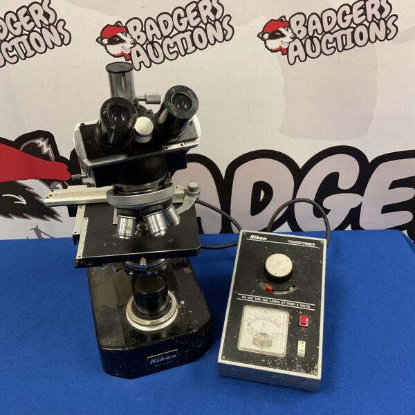 Vintage Nikon microscope with transformer power supply for scientific use.