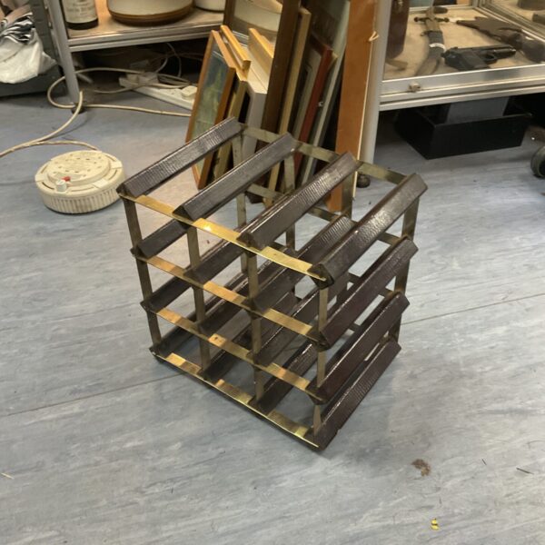 Vintage metal nine-bottle wine rack for home storage.