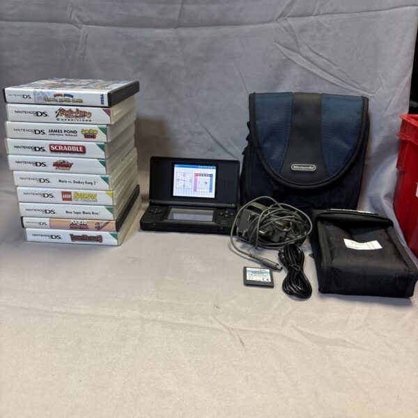 Black Nintendo DS Lite console with games and charger displayed.