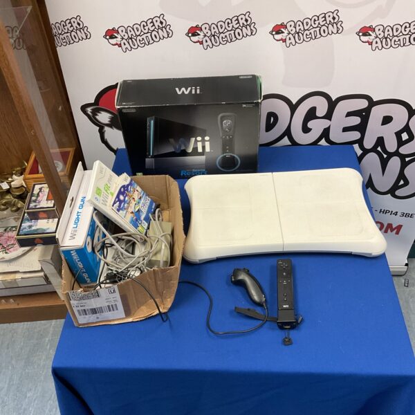 Nintendo Wii console with accessories, including Wii Sports and Wii Fit.