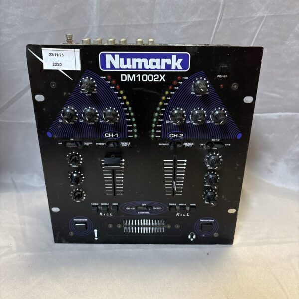 Vintage Numark DM1002X mixer with controls visible.