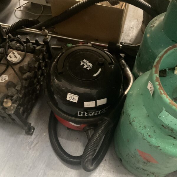 Red Numatic Henry Hoover with extension pole, vintage vacuum cleaner.