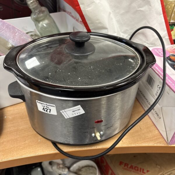 Front view of a used Nuo slow cooker kitchen appliance.