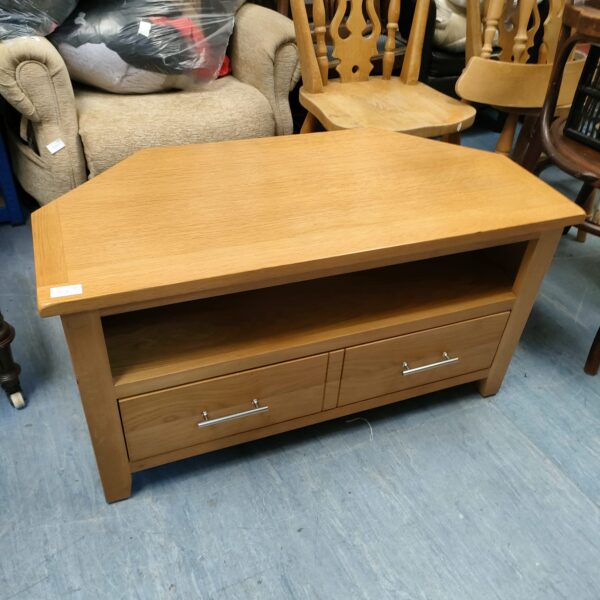 Vintage oak corner media cabinet with drawer and shelf.