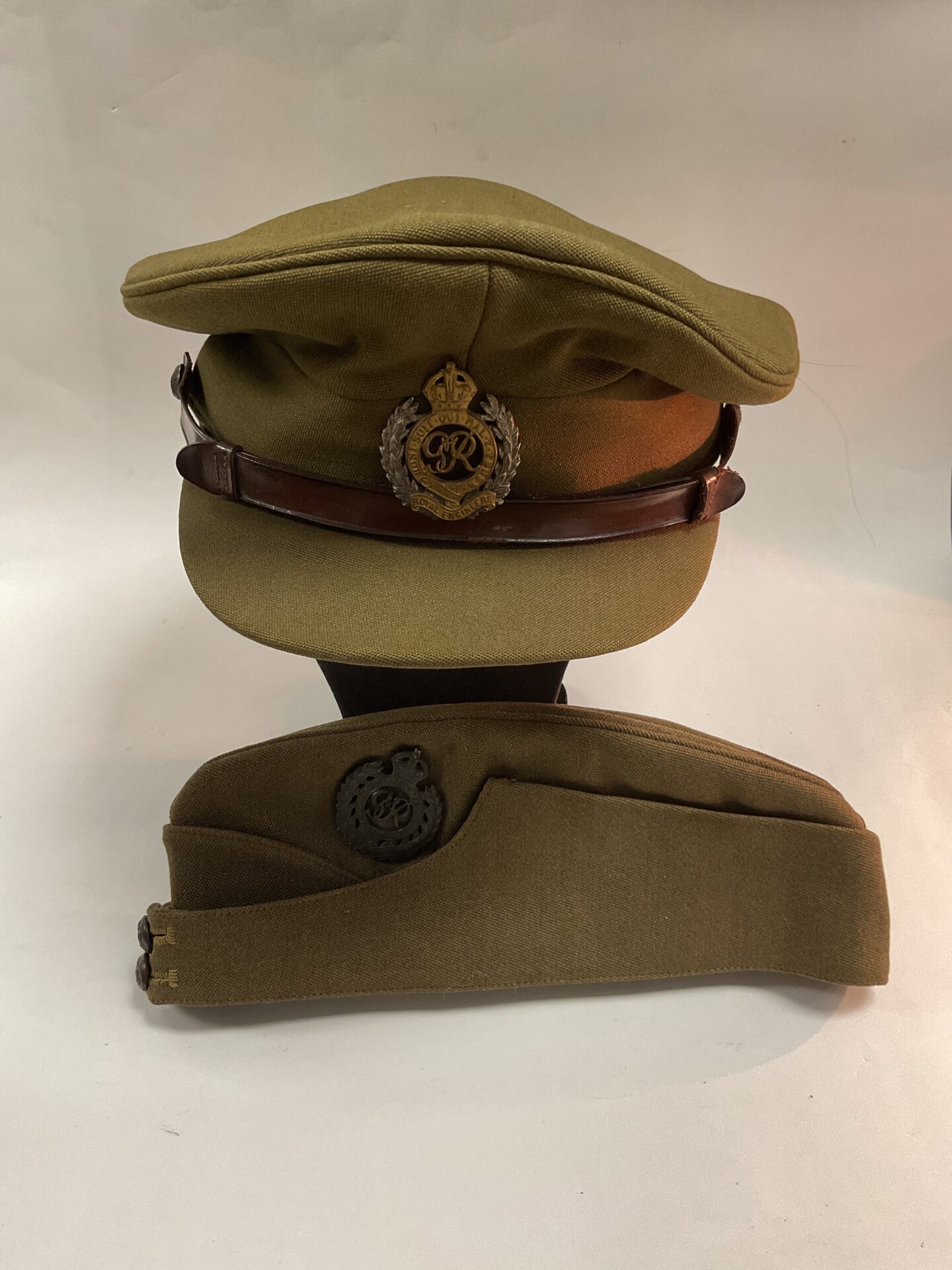 Two military caps, part of the British Army officer uniform.