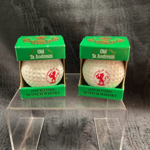 Vintage Old St Andrews golf balls, collectible whiskey memorabilia.
