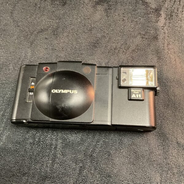 Front view of a vintage Olympus A11 35mm film camera.