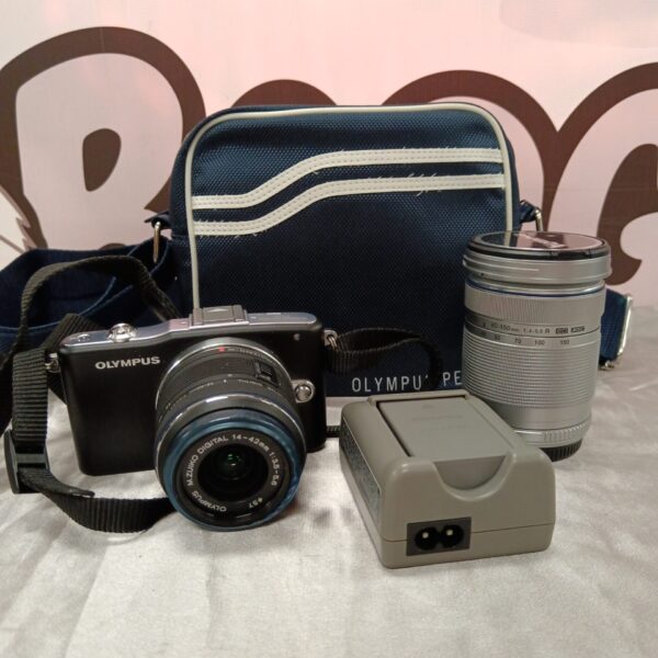 Olympus Pen Mini E-PM1 digital camera with lens and charger.