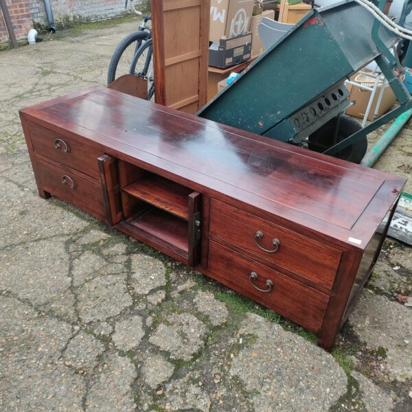 Large Oriental rosewood TV cabinet with carved details.